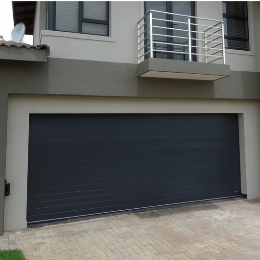 Aluminium sectional garage door with modern fluted panel design, corrosion resistant aluminium construction available in standard and caravan profiles.